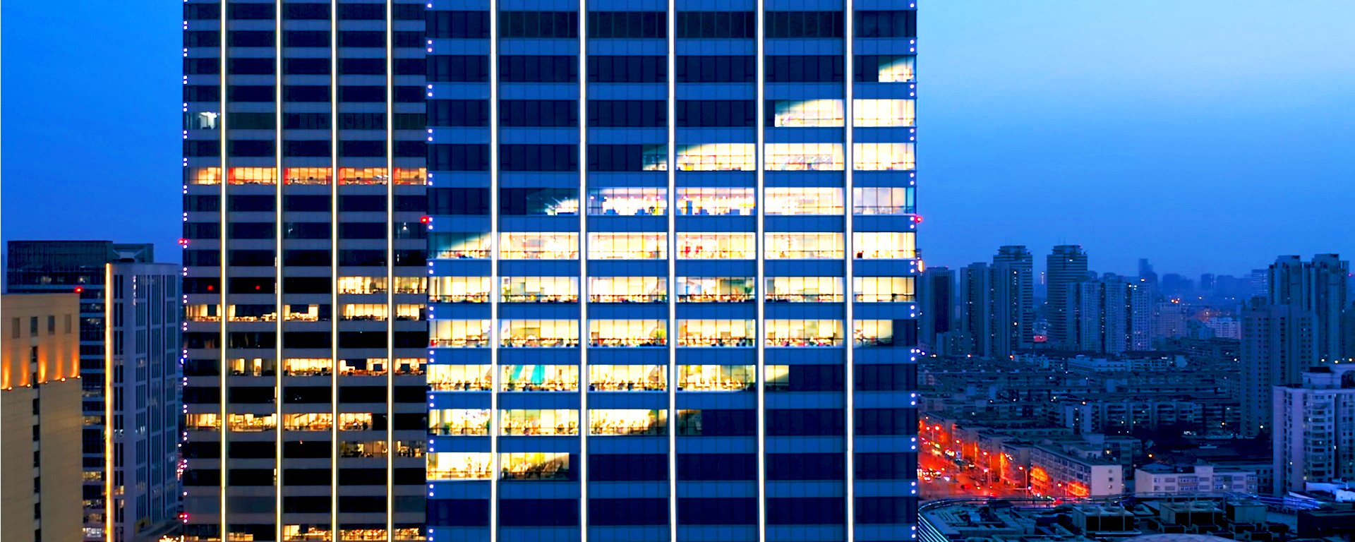 Building with lights in the shape of the Baird logo.